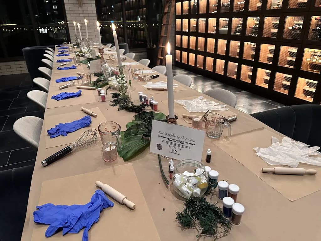 Table set up for a bath bomb workshop with candles and tools