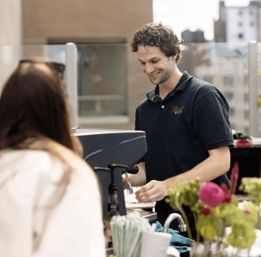 a barista behind an espresso machine