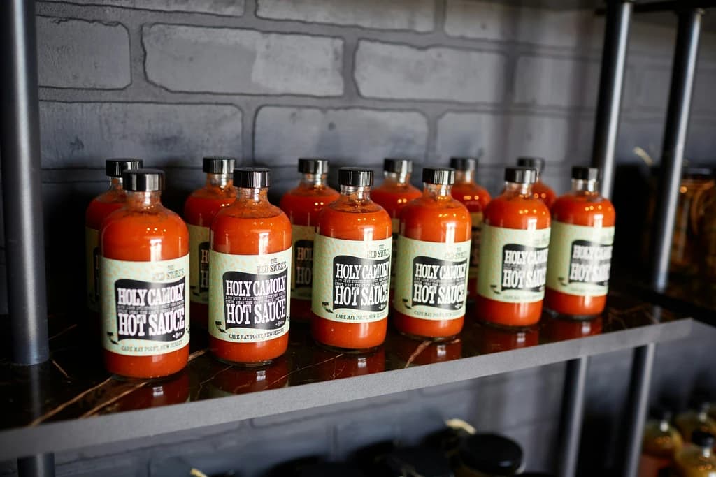 a shelf with hot sauces on it