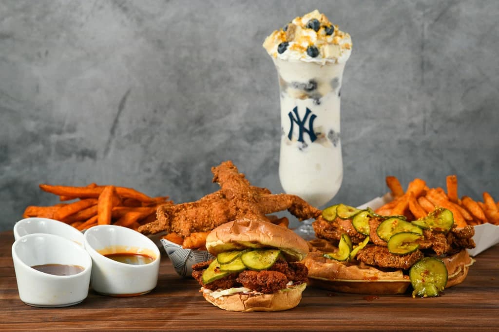 a table full of food and drinks with yankee logos on the cups